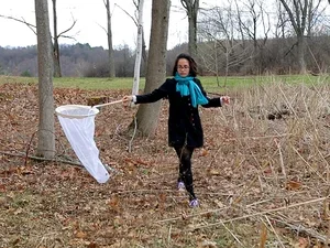 Student catching insects with net