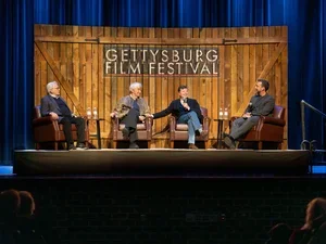 Image of Ken Burns Credit Gettysburg Images/Adams County Historical Society. Caption: Actors Martin Sheen (far left) and Sam Waterston (second from left) join documentary filmmaker Ken Burns (second from right) and moderator Jake Boritt (right) on stage for "Lessons from Lincoln" at the 2024 Gettysburg Film Festival on April 5, 2024.