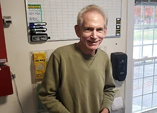 Rich Lederer | a man with grey hair and a green shirt 