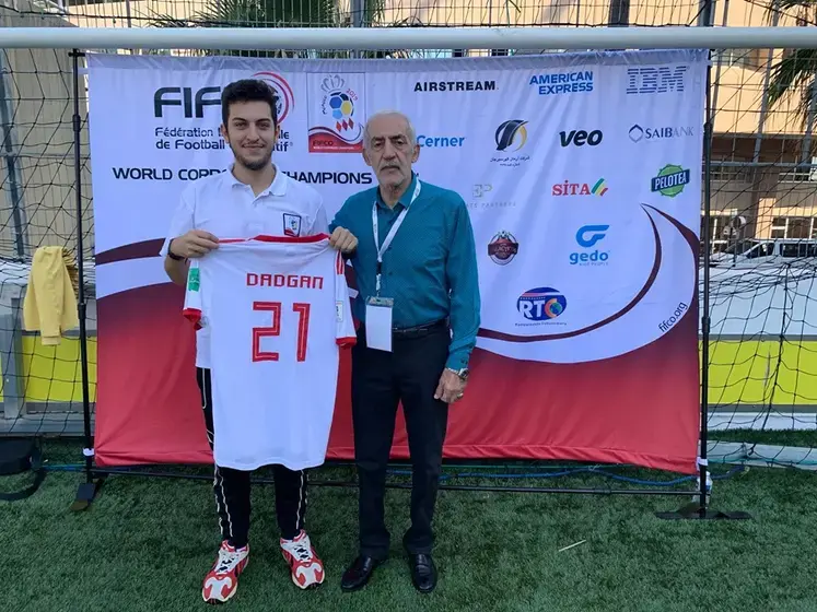 Photo of two men with soccer jersey