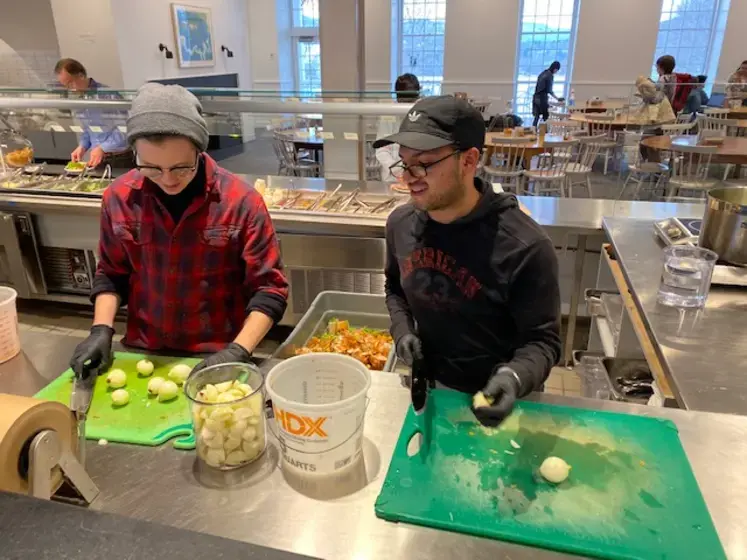Photo of two students cooking